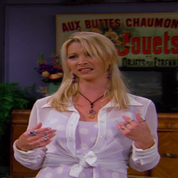 Phoebe wearing a mini dress and a shirt tied on top of it