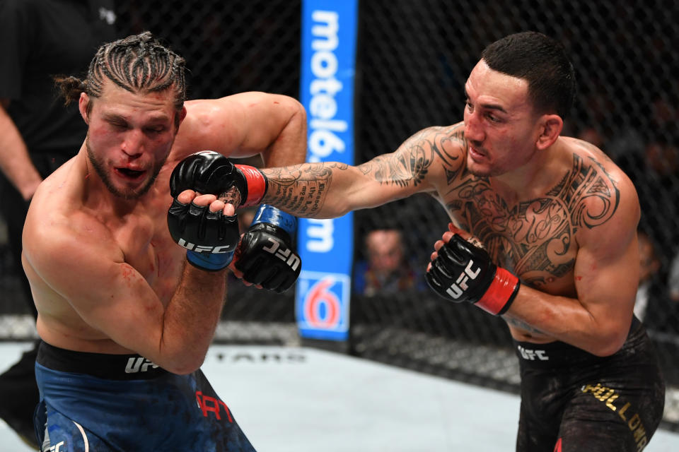 Max Holloway punches Brian Ortega in their UFC featherweight championship fight during UFC 231 at Scotiabank Arena on Dec. 8, 2018 in Toronto, Canada. (Getty Images)