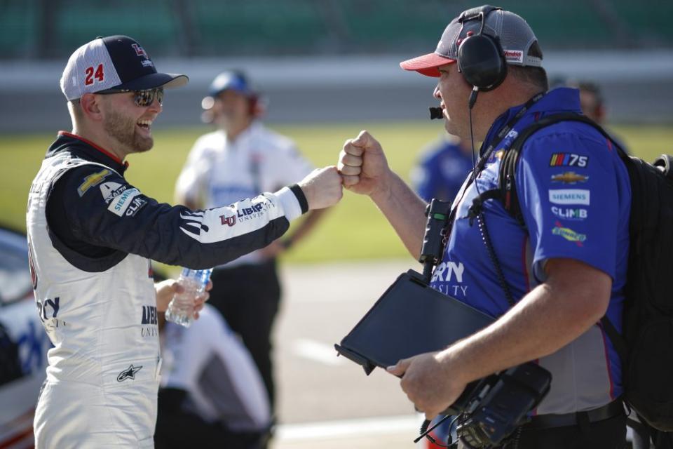 KANSAS CITY, KANSAS - MAY 06: William Byron, driver of the #24 Liberty University Chevrolet, fist bumps crew chief Rudy Fugle after winning the pole during qualifying for the NASCAR Cup Series Advent Health 400 at Kansas Speedway on May 06, 2023 in Kansas City, Kansas. (Photo by Sean Gardner/Getty Images)