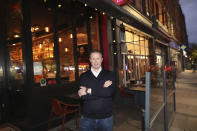 Paul Cadden, owner of the Saba restaurant group poses for a photograph in his restaurant in Dublin, Ireland, Wednesday, Oct. 21, 2020. Paul Cadden will have to lay off 20 people, but will do whatever is necessary to get through lockdown. With COVID-19 cases on the rise, the government has imposed a tough new lockdown, shutting down non-essential shops, limiting restaurants to takeout service and ordering people to stay within five kilometers (three miles) of their homes for the next six weeks. (AP Photo/Peter Morrison)