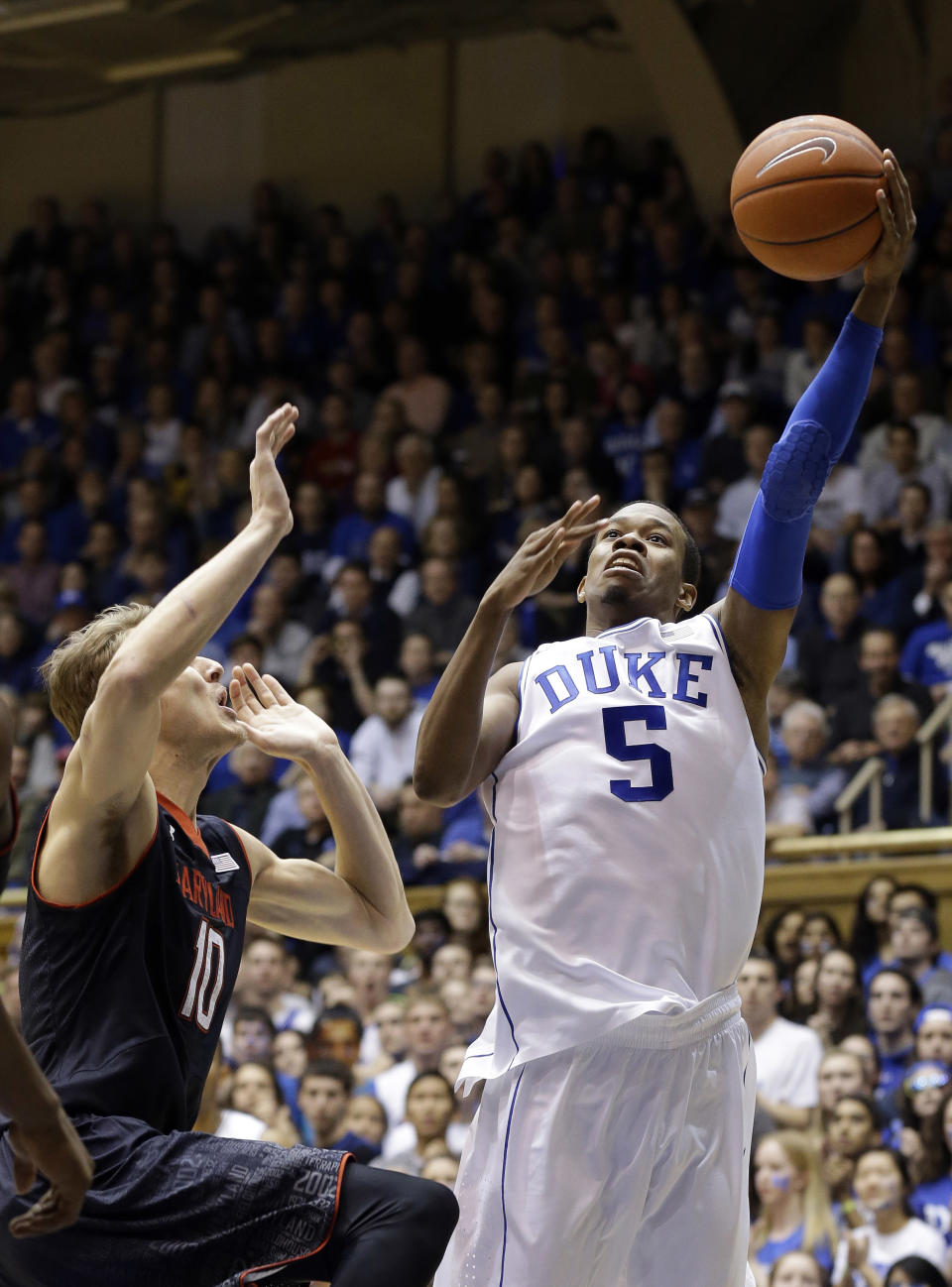 Duke's Rodney Hood (5) shoots as Maryland's Jake Layman (10) defends during the first half of an NCAA college basketball game in Durham, N.C., Saturday, Feb. 15, 2014. (AP Photo/Gerry Broome)