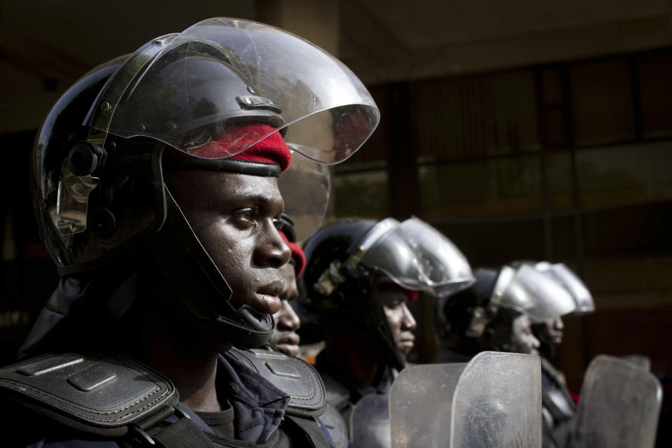 Police in riot gear stand guard at the site of an unauthorized anti-government protest in central Dakar, Senegal Wednesday, Feb. 22, 2012. Thousands of supporters turned out to see Senegalese President Abdoulaye Wade Wednesday as he held rallies in the downtrodden Pikine and Guediawaye suburbs. Daily protests have rocked the capital after the opposition vowed to render the country ungovernable if 85-year-old Wade runs for a third term in Sunday's elections.(AP Photo/Tanya Bindra)