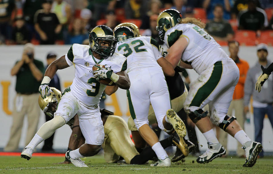 DENVER, CO - AUGUST 29: Treyous Jarrells #3 of the Colorado State Rams rushes three yard for a touchdown against the Colorado Buffaloes as the Buffaloes held a 17-14 lead in the third quarter in the Rocky Mountain Showdown at Sports Authority Field at Mile High on August 29, 2014 in Denver, Colorado. (Photo by Doug Pensinger/Getty Images)