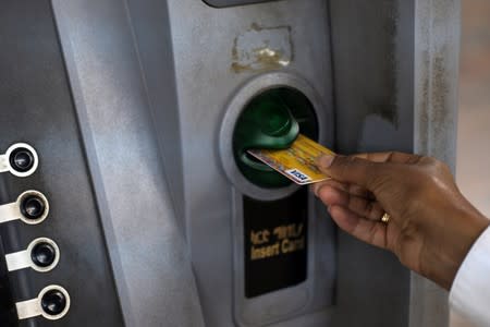 A client uses an automated teller machine (ATM) at the Commercial Bank of Ethiopia in Addis Ababa