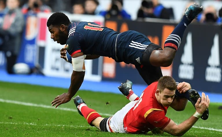 France's left wing Noa Nakaitaci (L) is tackled by Wales' left wing Liam Williams during the Six Nations international rugby union match March 18, 2017