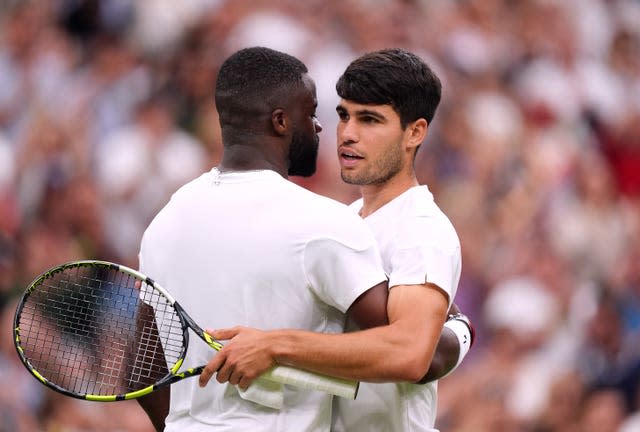 Carlos Alcaraz and Frances Tiafoe at the net 