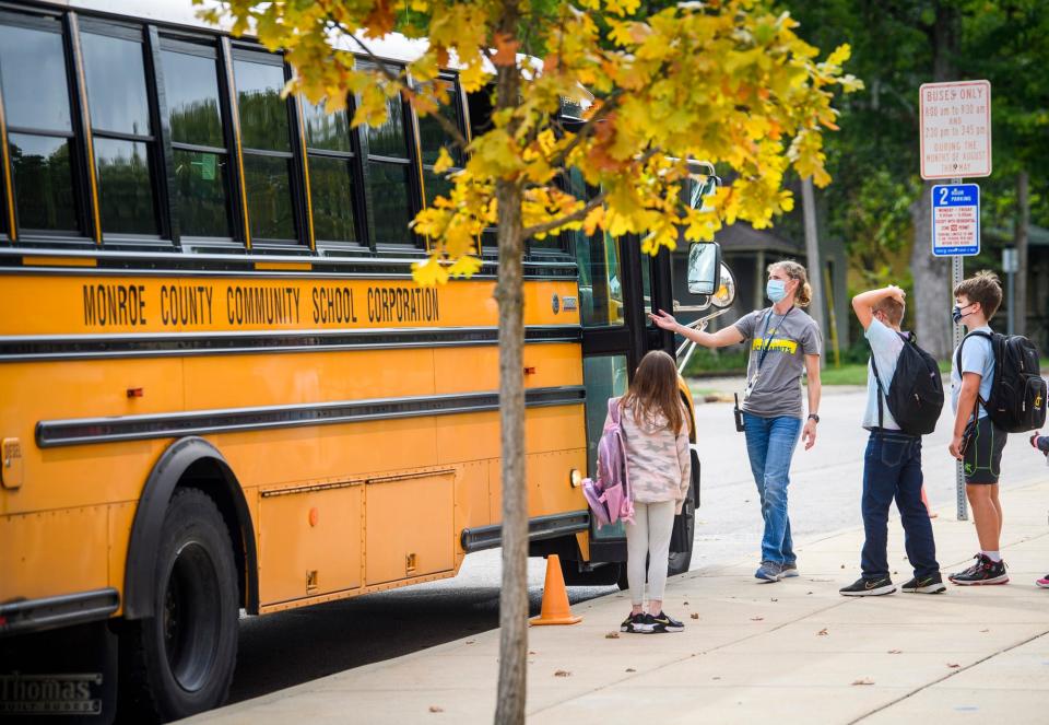 Fairview Elementary Assistant Principal Jamie Burkhar helps students get on a bus on Tuesday, Sept. 21, 2021.