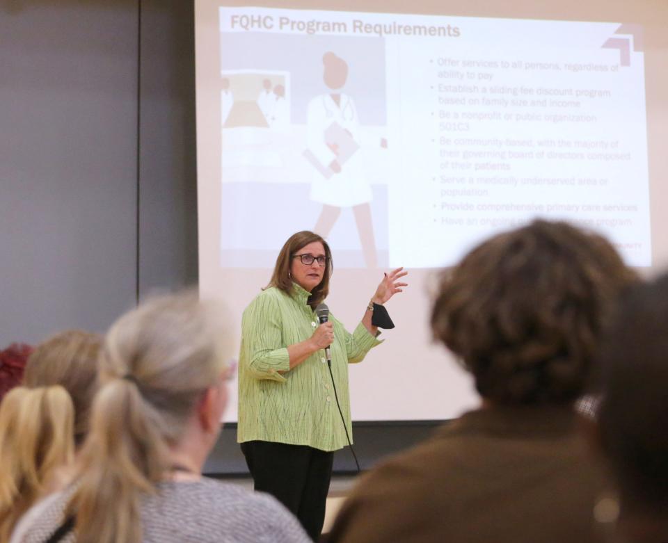 Terry Regula, CEO of My Community Health Center, speaks during Thursday's meeting for the southeast community to ask questions about the future grocery and health care center planned for Gonder Avenue in Canton.