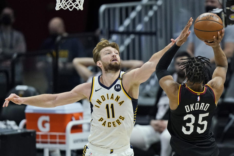 Indiana Pacers' Domantas Sabonis (11) blocks a shot by Cleveland Cavaliers' Isaac Okoro (35) in the second half of an NBA basketball game, Monday, May 10, 2021, in Cleveland. (AP Photo/Tony Dejak)