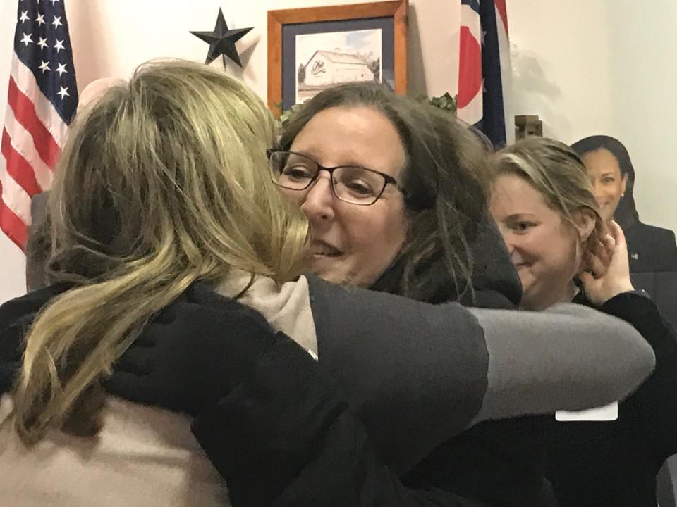 Richland County Domestic Relations Judge Heather Cockley gets numerous hugs from everyone in the room Tuesday at the Richland County Democratic Headquarters during a surprise celebration in her honor.