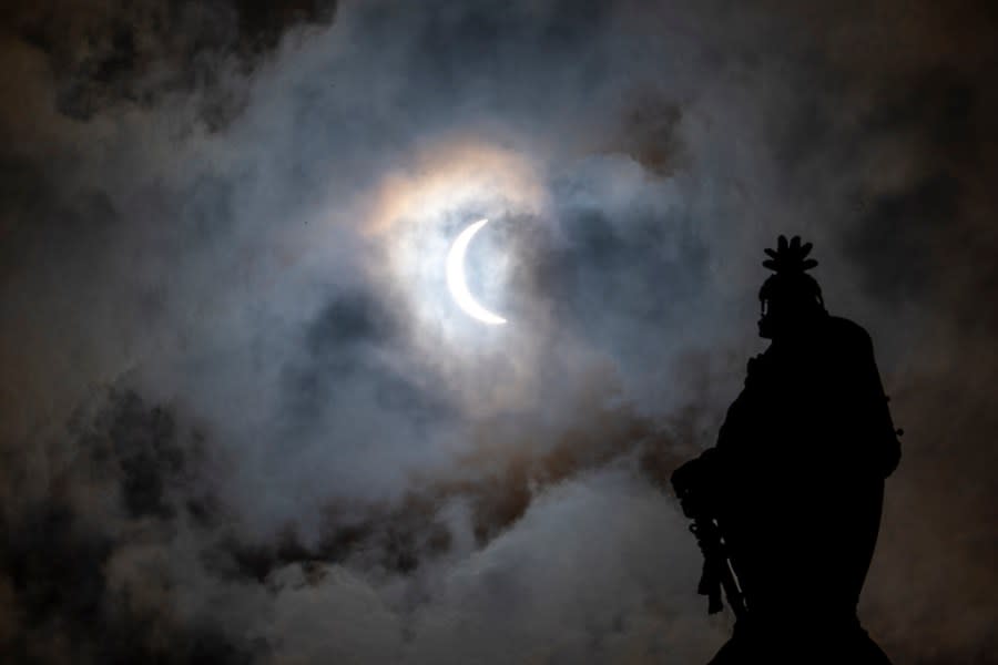 The Statue of Freedom on top of the U.S. Capitol stands as the moon partially covers the sun during a total solar eclipse, as seen from Capitol Hill, Monday, April 8, 2024, in Washington. (AP Photo/Alex Brandon)