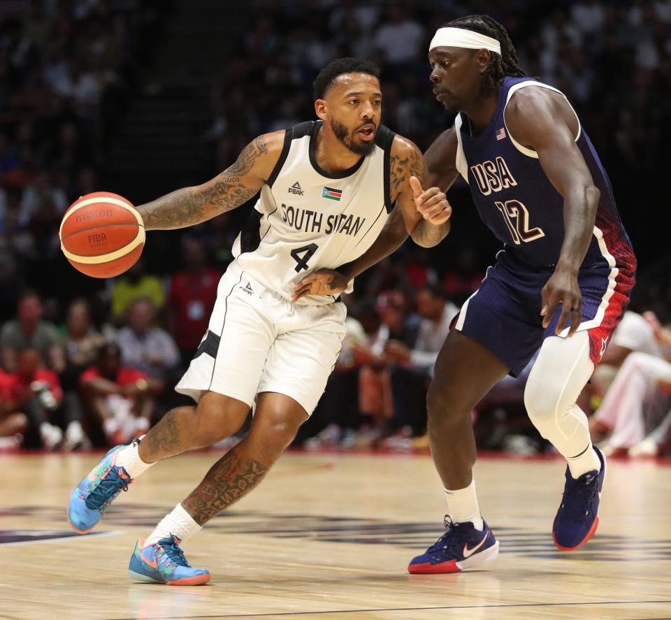 South Sudan's Carlik Jones dribbles the ball as the USA's Jrue Holiday defends.