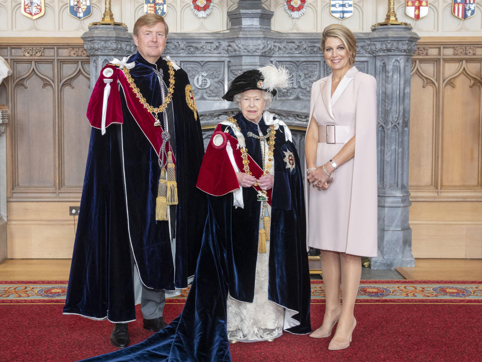 Queen Elizabeth II (centre) with King Willem-Alexander of the Netherlands and his wife, Queen Maxima, in St George's Hall, at Windsor Castle, after the king was invested as a Supernumerary Knight of the Garter, ahead of the Order of the Garter Service at St George's Chapel.