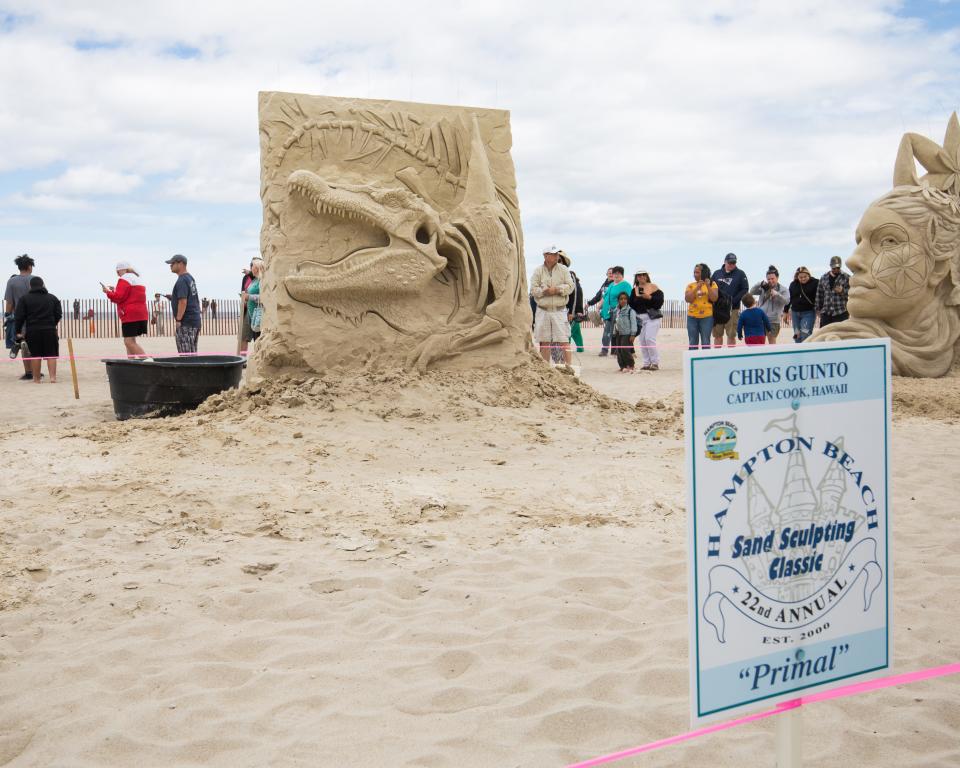 Chris Guinto, of Captain Cook, Hawaii, with his piece "Primal" at the 2022 Hampton Beach Master Sand Sculpting Classic Saturday, June 18.