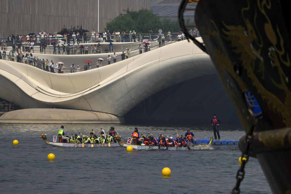 Competitors take part in a dragon boat race during the Dragon Boat Festival at a canal in Tongzhou, outskirts of Beijing, Monday, June 10, 2024. The Duanwu Festival, also known as the Dragon Boat Festival, falls on the fifth day of the fifth month of the Chinese lunar calendar and is marked by eating rice dumplings and racing dragon boats. (AP Photo/Andy Wong)