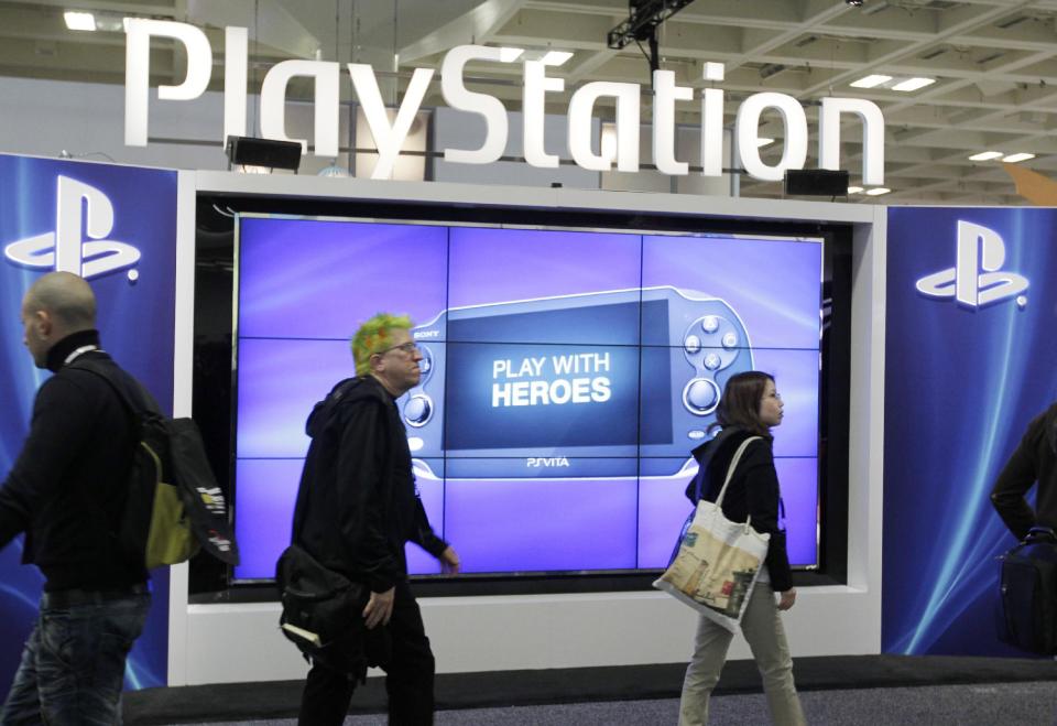 FILE- This March 8, 2012 file photo shows attendees walking past the Sony PlayStation PS Vita console on display in the Sony PlayStation booth at the Game Developers Conference in San Francisco. Despite a refreshed focus on real-world issues at the 2014 GDC convention that kicks-off Monday, March 17, 2014, the ever-changing virtual world and how to view and interact with it will take center stage at GDC. PlayStation 4 creator Sony Corp. is expected to tease its rendition of virtual reality technology during a Tuesday presentation called "Driving the Future of Innovation at Sony Computer Entertainment." (AP Photo/Paul Sakuma, file)