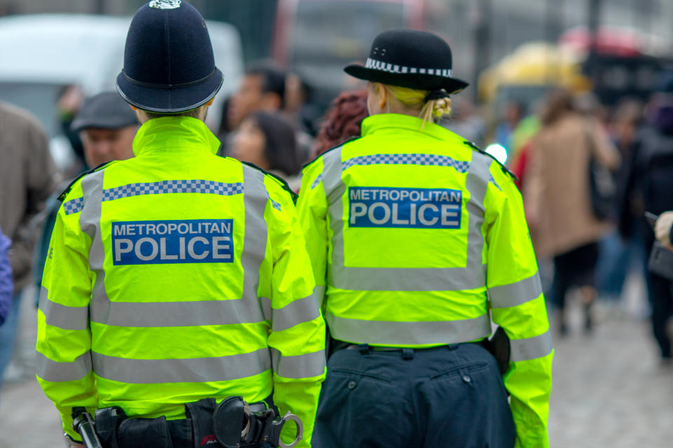 3rd May, 2019 - Metropolitan policeman and Policewoman in High Vis jackets looking at crowds in Westminster, central London
