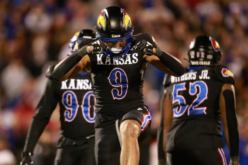 Kansas redshirt sophomore defensive lineman Austin Booker (9) reacts after a sack in the fourth quarter of Saturday’s Sunflower Showdown against Kansas State inside David Booth Kansas Memorial Stadium.