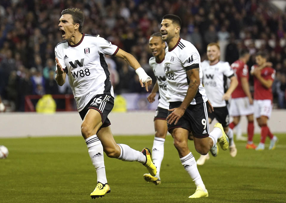 Fulham's Joao Palhinha, left, celebrates scoring their side's second goal of the game with team-mates during the English Premier League soccer match between Nottingham Forest and Fulham, at The City Ground, Nottingham, England, Friday Sept. 16, 2022. (Tim Good/PA via AP)