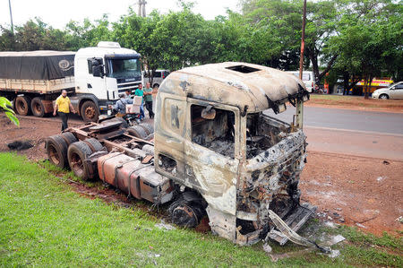 A truck burned near the headquarters of private security company Prosegur is pictured in Ciudad del Este, eastern Paraguay, April 24, 2017, after a group of dozens of people carried out an assault with explosives at the site. REUTERS/Francisco Espinola