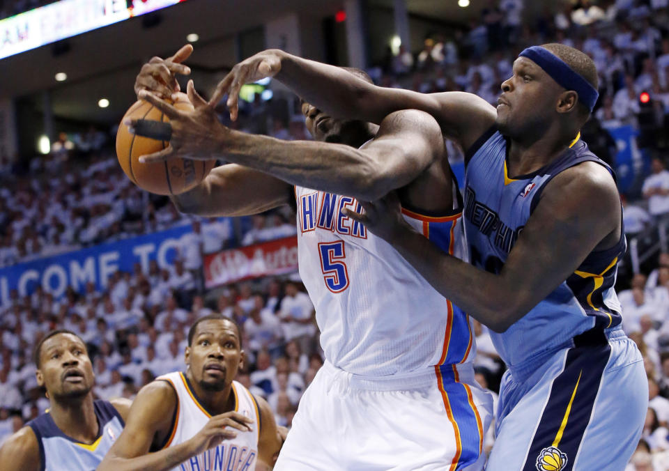Oklahoma City Thunder center Kendrick Perkins (5) and Memphis Grizzlies forward Zach Randolph reach for a rebound in the second quarter of Game 5 of an opening-round NBA basketball playoff series in Oklahoma City, Tuesday, April 29, 2014. (AP Photo)