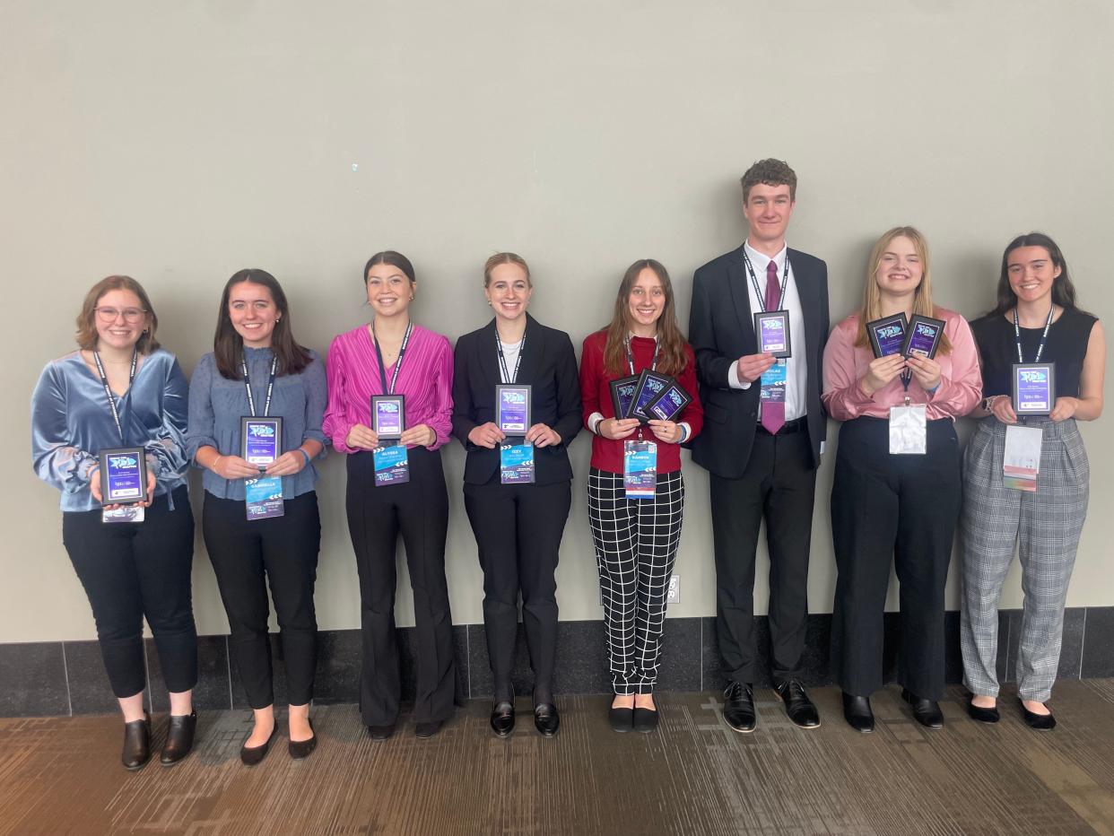 Members of the East Jordan High School Business Professionals of America chapter, (from left) Hannah Fortune, Gabby Hamilton, Alyssa Sherman, Izzy Boyer, Kamryn Webb, Nick Bascom, Lila Kelly and Mailey Hamilton, pose with their awards after a competition.