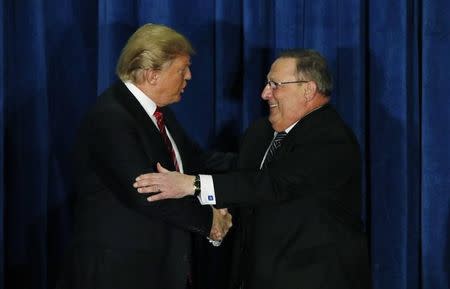 Republican U.S. presidential candidate Donald Trump shakes hands with Maine Governor Paul LePage (R) after LePage introduced him at a campaign rally in Portland, Maine March 3, 2016. REUTERS/Joel Page