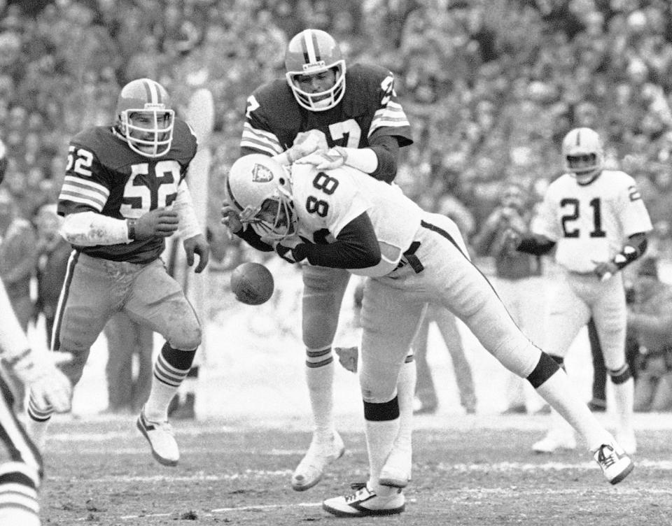 Browns safety Thom Darden (27) breaks up a pass for Raiders tight end Raymond Chester (88) as linebacker Dick Ambrose (52) moves in during an AFC playoff game in Cleveland, Jan. 4, 1981. (AP Photo, File)