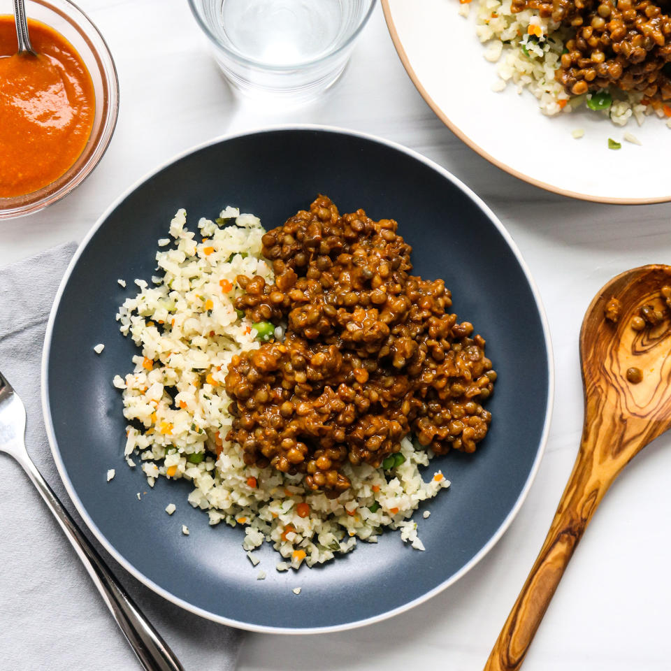 <p>Combine precooked lentils (often located in the produce section of your grocery store) with an Indian-style simmer sauce for a super-fast and flavorful curry. Serving it over riced cauliflower bumps up the vegetable count and keeps carb servings in check. This 3-ingredient dinner (not counting salt, pepper and oil) is really as easy as it gets. To be mindful of the salt, look for simmer sauces with less than or close to 350 mg sodium per ¼-cup serving. <a href="https://www.eatingwell.com/recipe/7886568/lentil-curry-with-cauliflower-rice/" rel="nofollow noopener" target="_blank" data-ylk="slk:View Recipe;elm:context_link;itc:0;sec:content-canvas" class="link ">View Recipe</a></p>