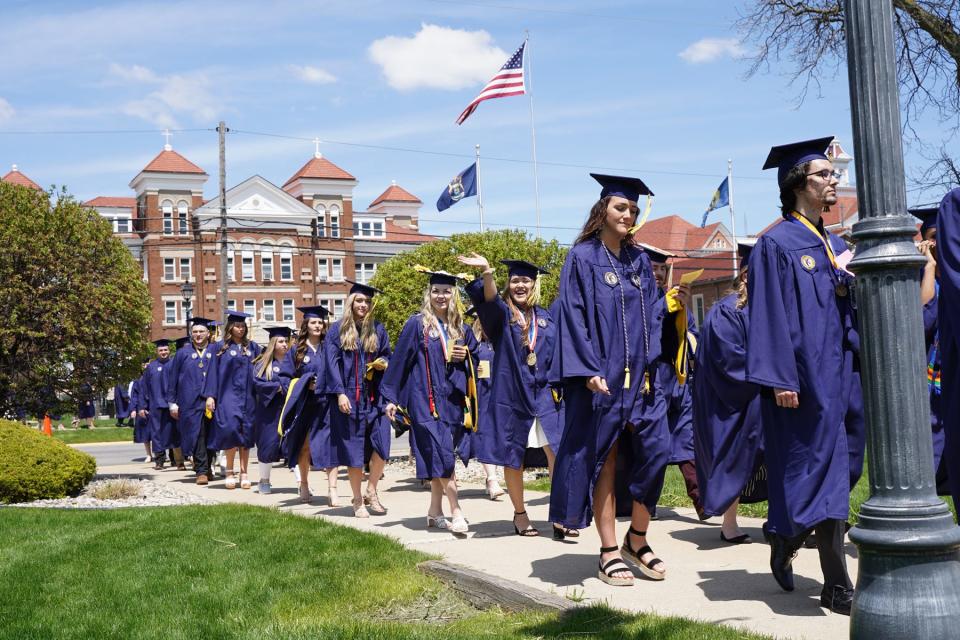 Graduates march into the Siena Heights University fieldhouse for commencement May 8, 2022.