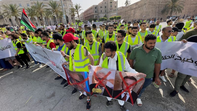 People protest against a power outage inside Martyrs' Square, in Tripoli