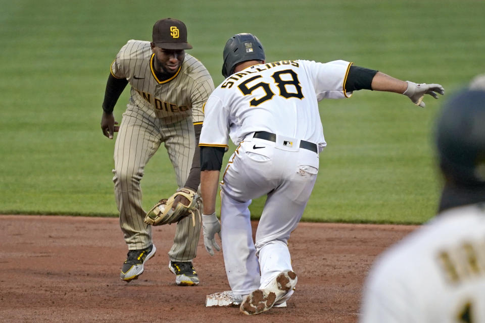 Pittsburgh Pirates' Jacob Stallings (58) slides safely into second with a double ahead of the tag by San Diego Padres second baseman Jurickson Profar during the first inning of a baseball game in Pittsburgh, Tuesday, April 13, 2021. (AP Photo/Gene J. Puskar)