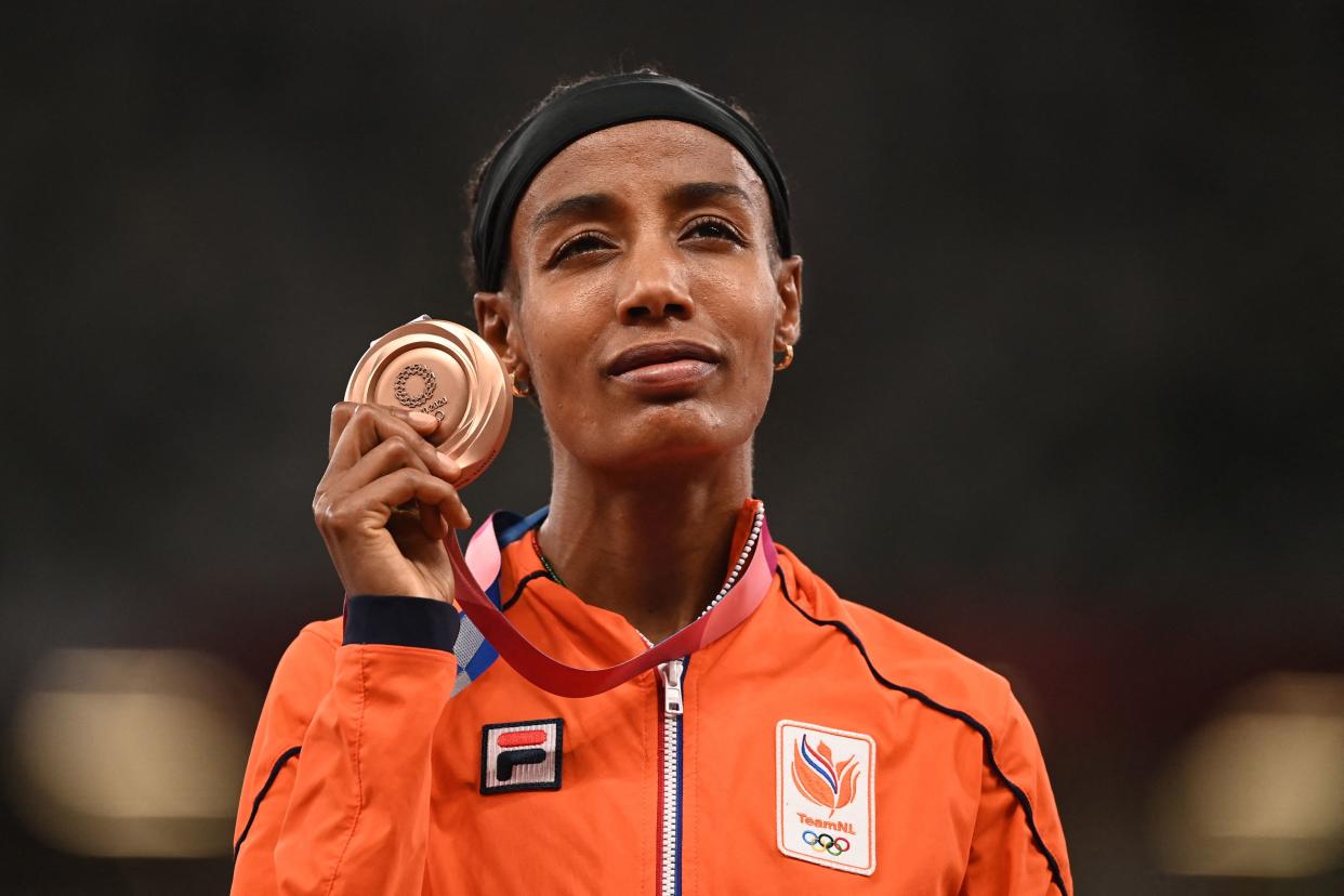 Bronze medallist Netherlands' Sifan Hassan celebrates on the podium during the medal ceremony for the women's 1500m final during the Tokyo 2020 Olympic Games at the Olympic Stadium in Tokyo on August 6, 2021. (Photo by Ina FASSBENDER / AFP) (Photo by INA FASSBENDER/AFP via Getty Images)