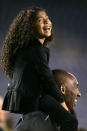 Kobe Bryant stands on the sideline with his daughter Gianna Maria-Onore Bryant on his shoulders prior to the start of the game against the United States and China during an international firendly match at Qualcomm Stadium on April 10, 2014 in San Diego, California. (Photo by Kent C. Horner/Getty Images)