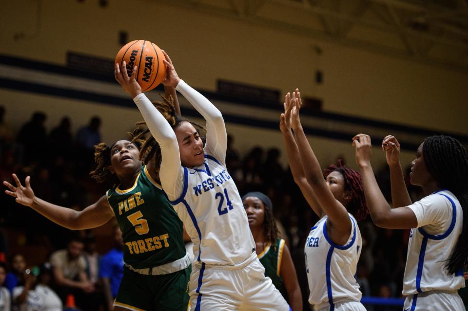 Karma Hernandez tries to keep the ball away from Tahlia Glover (5) during Pine Forest at Westover girls basketball on Tuesday, Dec. 6, 2022.