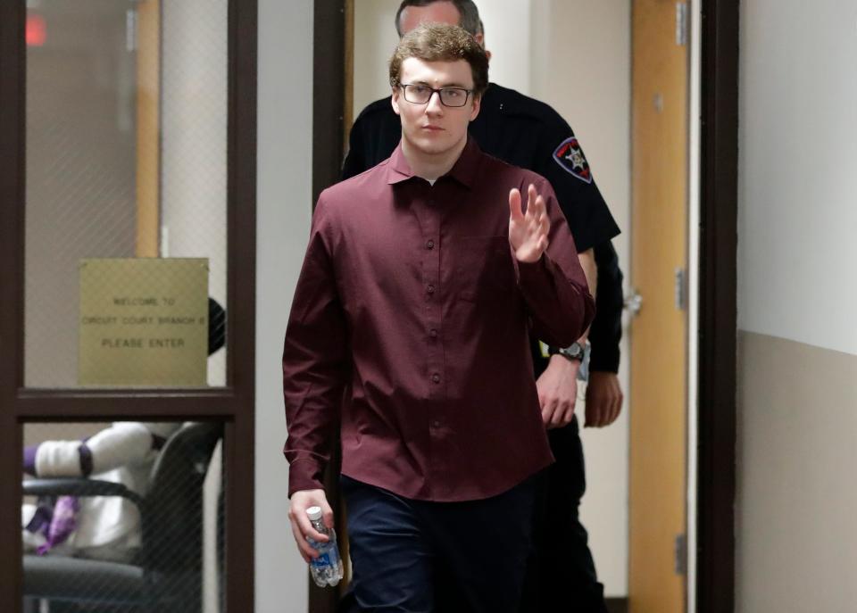 Grant Fuhrman waves as he exits the courtroom for a mid-day break Jan. 24 in the Branch 6 courtroom at the Winnebago County Courthouse in Oshkosh.