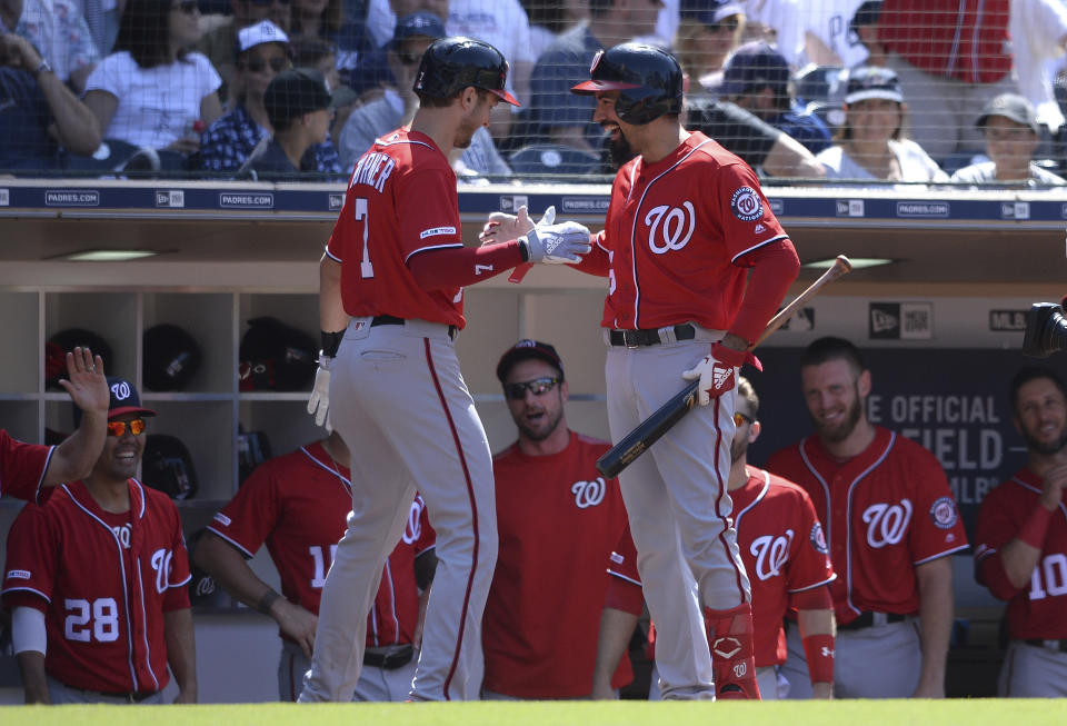 Washington Nationals' Trea Turner, front left, is congratulated at the dugout by Anthony Rendon after hitting a home run during the eighth inning of a baseball game against the San Diego Padres, Sunday, June 9, 2019, in San Diego. (AP Photo/Orlando Ramirez)