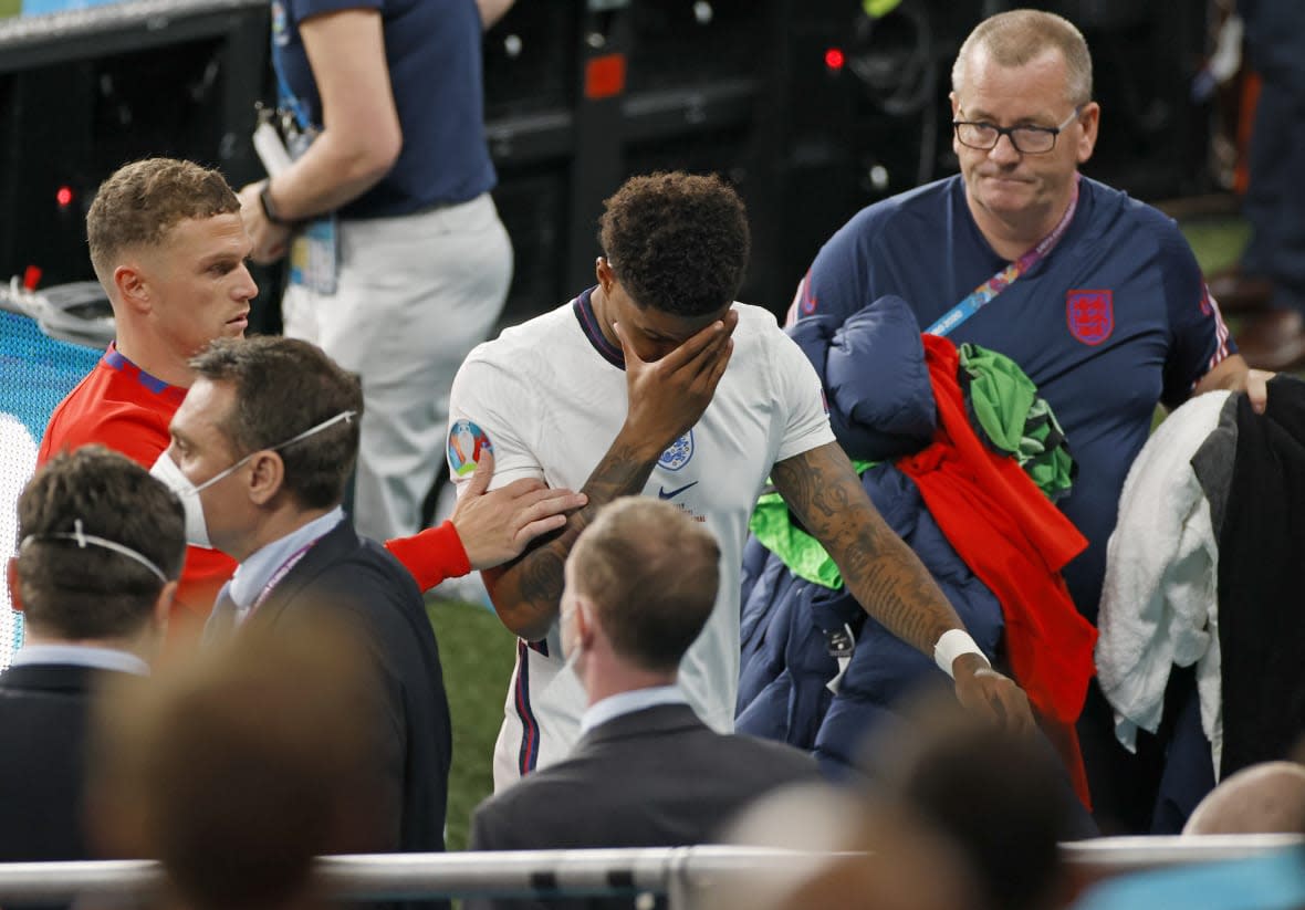 FILE – England’s Marcus Rashford reacts as he leaves the pitch after a loss in a penalty shootout against Italy at the Euro 2020 soccer championship final at Wembley stadium in London, Sunday, July 11, 2021. Missing penalties in a major international soccer final was bad enough for three Black players, Rashford, Jadon Sancho and Bukayo Saka, who were on England’s national team. Being subjected to a torrent of racial abuse on social media in the aftermath made it even worse. (John Sibley/Pool Photo via AP, File)