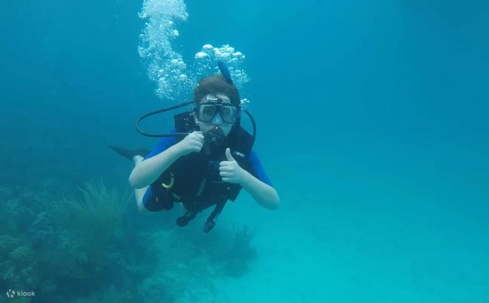 solo travel destination - woman scuba diving