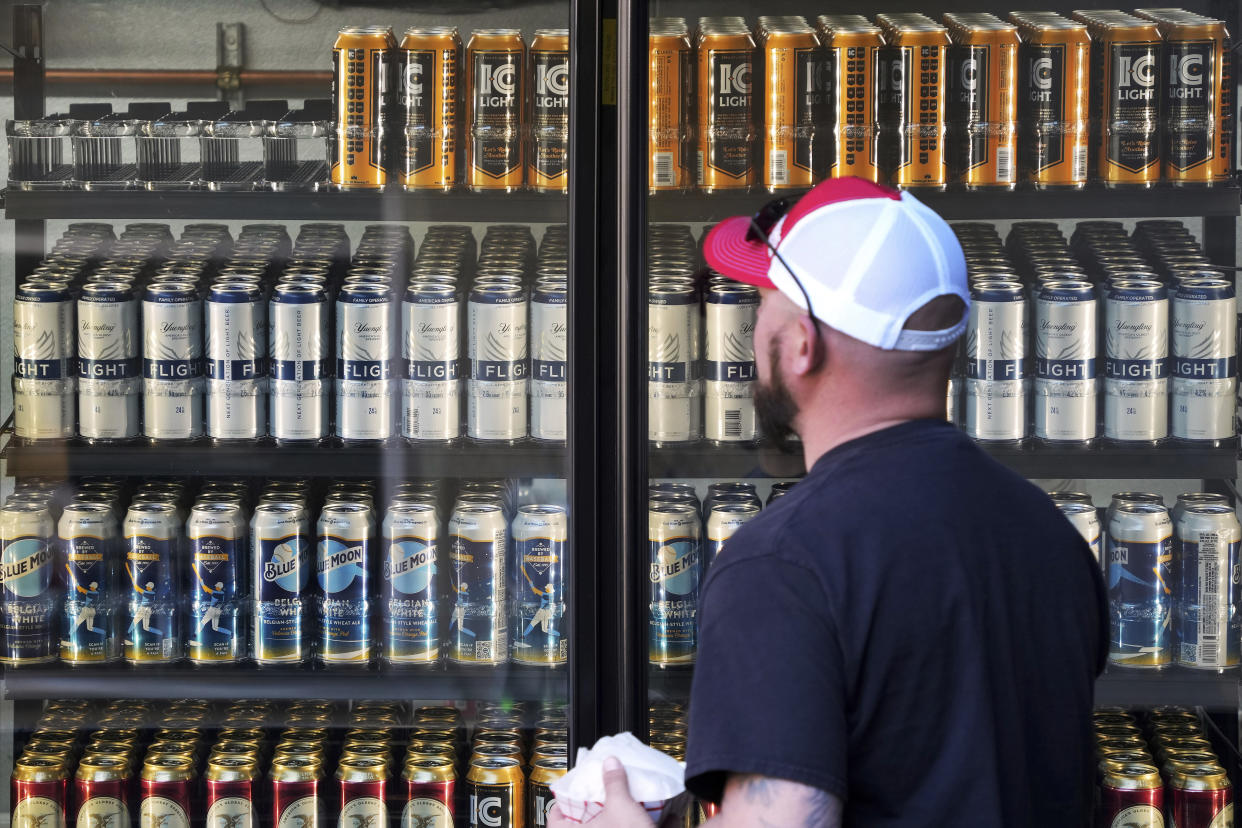 A baseball fan looks at the offerings in a beer cooler at PNC Park before a baseball game between the Pittsburgh Pirates and the Houston Astros in Pittsburgh, Wednesday, April 12, 2023. (AP Photo/Gene J. Puskar)