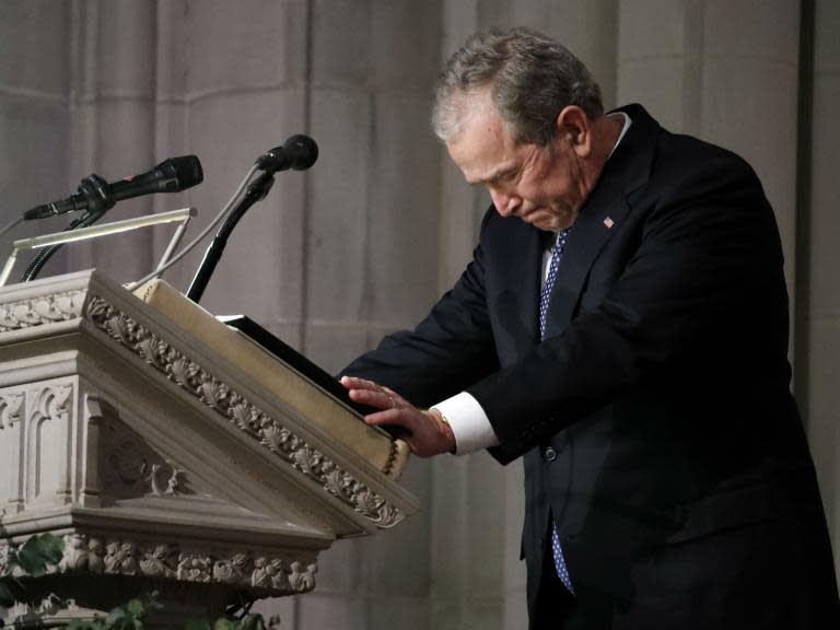 George HW Bush given emotional sendoff by son at funeral – as Trump is given the cold shoulder