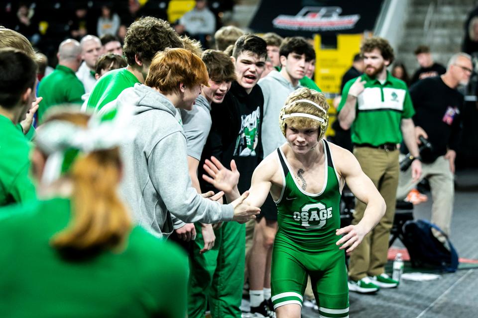 Osage's Anders Kittelson high-fives teammates before wrestling at 132 pounds during the Class 2A boys state wrestling duals against West Delaware, Saturday, Feb. 4, 2023, at Xtream Arena in Coralville, Iowa.