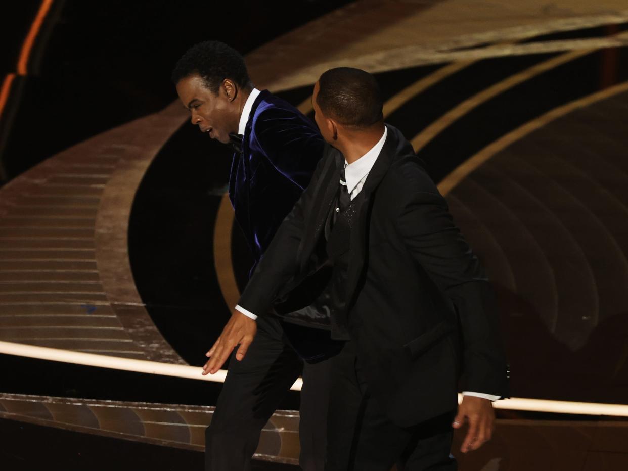 Will Smith slaps Chris Rock onstage during the Oscars.