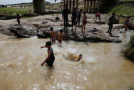 Iraqi youths swim as they enjoy their Friday holiday at Shallalat district (Arabic for "waterfalls") in eastern Mosul, Iraq, April 21, 2017. REUTERS/ Muhammad Hamed