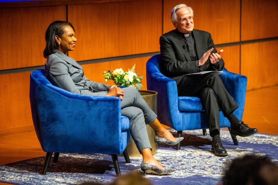 Former U.S. Secretary of State Condoleezza Rice smiles as Notre Dame President Rev. John Jenkins claps during the "A Conversation With: Condoleezza Rice" event Thursday, April 28, 2022, at the Mendoza College of Business on Notre Dame's campus. The two served together on a 14-member Commission on College Basketball in 2017, and changes in the NCAA were part of their conversation.