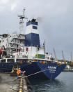 In this photo provided by the Ukrainian Infrastructure Ministry Press Office, the Razoni cargo ship, under the flag of Sierra Leone, with 26,000 tons of the Ukrainian corn aboard, leaves the port in Odesa region, Ukraine, Monday, Aug. 1, 2022. The first ship carrying Ukrainian grain set off from the port of Odesa on Monday under an internationally brokered deal and is expected to reach Istanbul on Tuesday, where it will be inspected, before being allowed to proceed. (Ukrainian Infrastucture Ministry Press Office via AP)