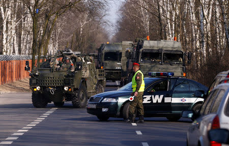 A convoy of British troops, a part of NATO's reinforcement of its eastern flank, who are on their way from Germany to Orzysz in northeast Poland, arrive at a military base in Wesola, near Warsaw, Poland, March 28, 2017. REUTERS/Kacper Pempel