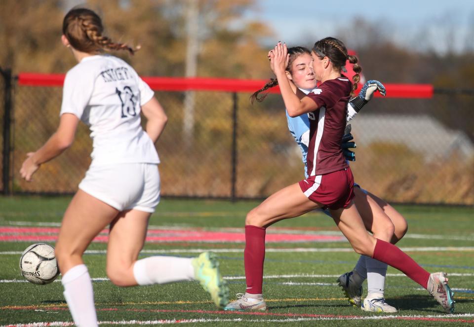 Aquinas's Jaden Deming gets the ball past a charging Sutherland goalkeeper Madison Littlefield and puts it in the open net for a goal.