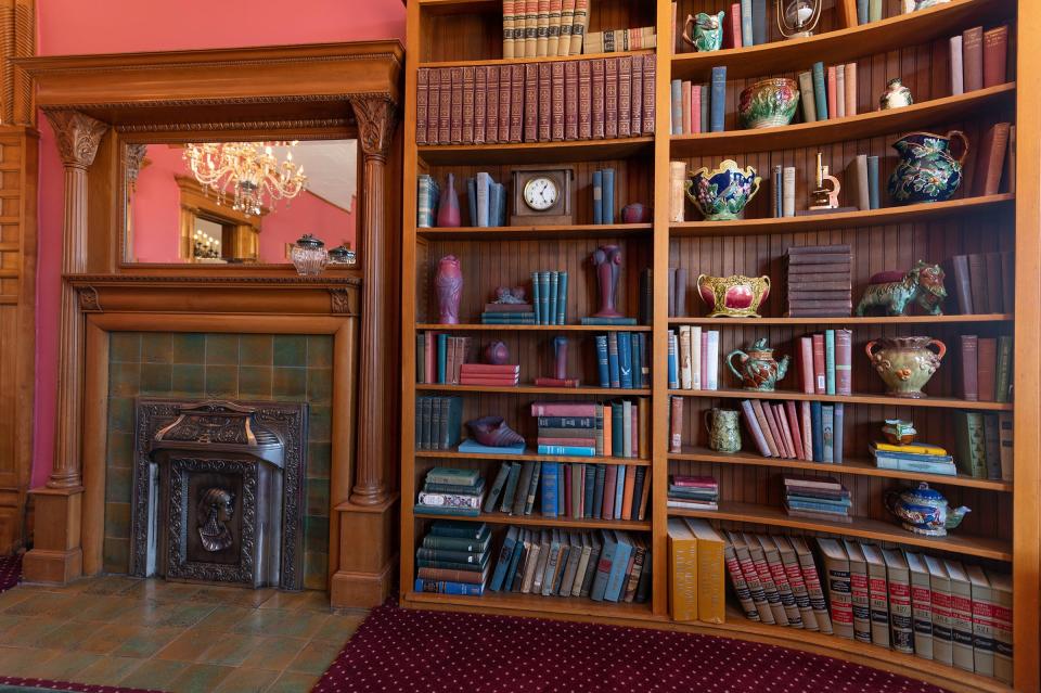 A bookshelf and fireplace on the first floor of the Orman Mansion, at 102 W. Orman Ave., are pictured.