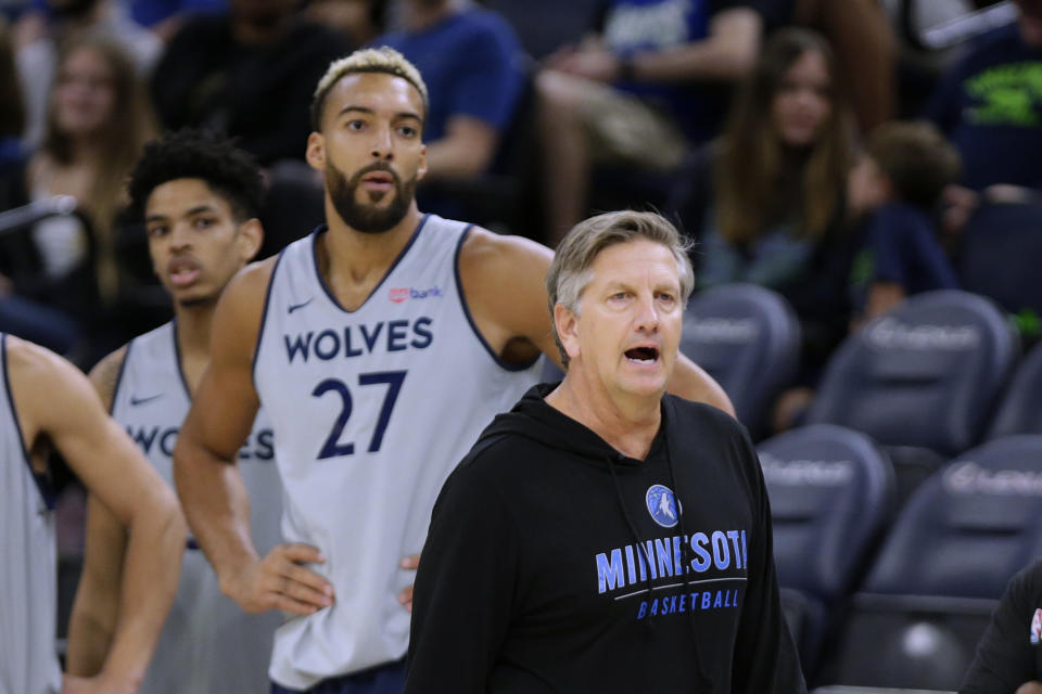 Minnesota Timberwolves coach Chris Finch directs practice for the NBA basketball team, while new Timberwolves center Rudy Gobert (27) watches, Saturday, Oct. 1, 2022, in Minneapolis. (AP Photo/Andy Clayton-King)